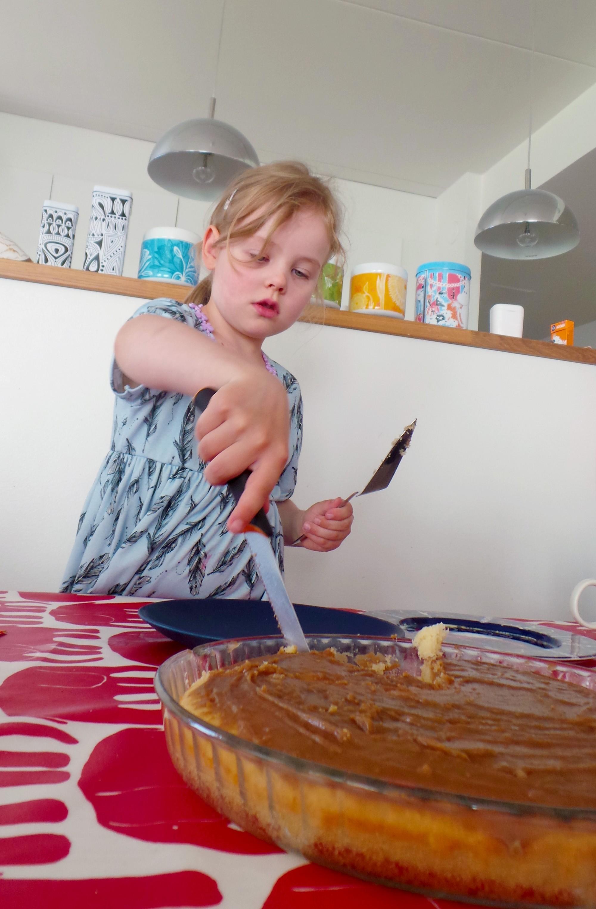 lapsi leikkaa kakkua